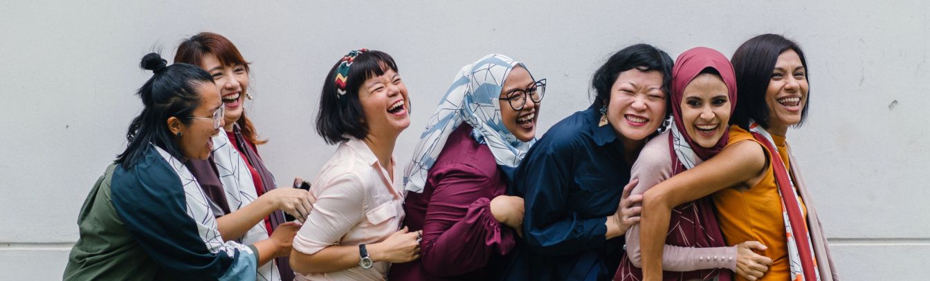 Women standing in a line and laughing